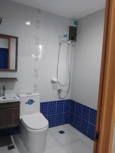 a bathroom with a toilet and a sink and a shower at Mori Residence in Malolos +14 photos