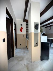 a hallway of a house with a kitchen and stairs at Uniejów PORT in Uniejow +24 photos