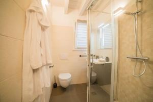 a bathroom with a toilet and a glass shower at Sweet Loft Maglie in Maglie +6 photos