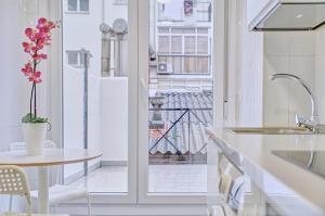 a kitchen with a table and a view of a balcony at Apartamento Burlada By Clabao in Burlada +19 photos