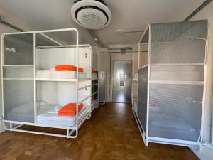 a room with two bunk beds and a hallway at Casali Hostel in Trieste