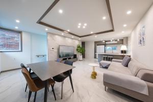 a living room with a table and a couch at Gangneung Brick Forest in Gangneung