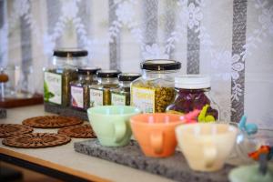 a counter with jars of jam and cookies on a table at Seogwipo Hineni Private House in Seogwipo