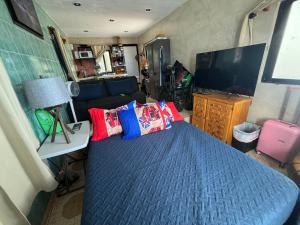 a bedroom with a bed and a tv in a rv at Apartment Suite Deluxe Isla Mujeres Sea View Vista al Mar in Isla Mujeres