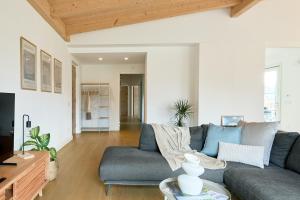 a living room with a couch and a table at Casa Montesei di TSS' -Ampio, di classe, vista e posto auto in Pergine Valsugana
