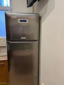 a stainless steel refrigerator in a kitchen at Cozy apartment in the heart of Baku in Baku +35 photos