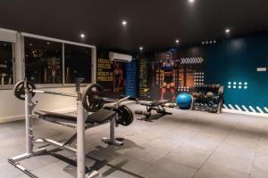 a gym with two treadmills and a gym at The Grand Central in Dona Paula