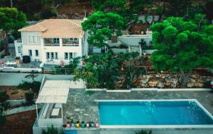 an aerial view of a house and a swimming pool at Hippie Bay Complex in Porto Rafti