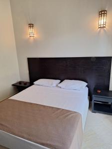 a bedroom with a large bed and two night stands at Villa des oliviers in Marrakech +19 photos