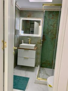 a bathroom with a sink and a shower at Golden Station Ultraconfort in Iaşi +17 photos