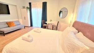 a bedroom with a white bed with towels on it at Jako Boutique in Jerusalem