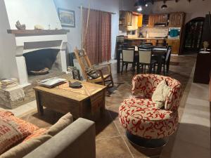 a living room with a fireplace and a table and chairs at QUINTA LA ARAUCARIA -Paraná in Paraná