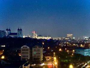a view of a city at night with lights at Golden Station Ultraconfort in Iaşi