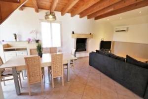 a living room with a table and chairs and a fireplace at Chez Lily in Domme