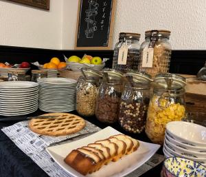 a table topped with jars of food and other foods at Guest House Torci 18 in Novigrad Istria