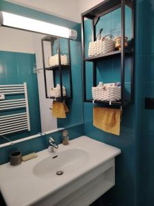 a bathroom with a sink and a mirror at Bel appartement au pied des pistes de serre chevalier in Briançon +13 photos