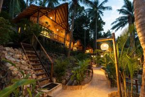 a resort with a staircase leading up to a building at Coconut Bay Eco Resort in Srithanu