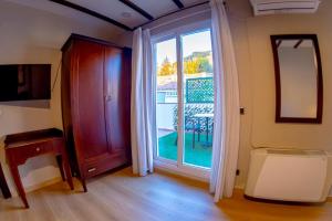 a room with a large glass door with a window at Hotel Tharsis in Cazorla