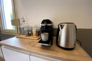 a coffee maker sitting on top of a counter at Le Saint-Maimboeuf-Au calme dans une résidence privée-Parking gratuit in Montbéliard +6 photos