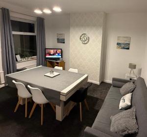 a living room with a table and a couch at Rotherham Kimberworth in Kimberworth