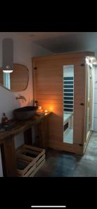 a bathroom with a counter with a sink and a mirror at Loveroom himeros, gîte de charme avec spa in Yerville +23 photos