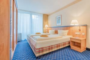 a hotel room with a large bed and a window at Chalet Sonnenhang Oberhof in Oberhof
