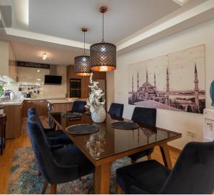 a dining room with a table and chairs at Vila Tayra in Sarajevo