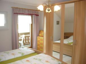 a bedroom with two beds and a mirror at Berghaus Edelstein in Bodenmais in Bodenmais