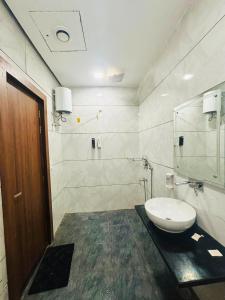 a bathroom with a toilet and a sink at Amarvilas Hotel & Resort in Bharatpur