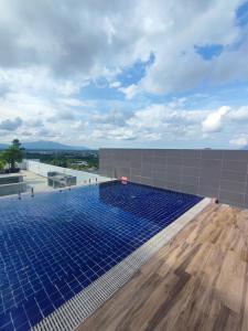 a swimming pool on the roof of a building at Kuching Podium Apartment Near Aeon Mall 3rd Mile in Kuching