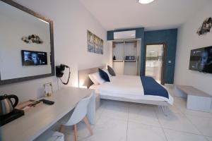 a hotel room with a bed and a desk and a desk at The Exiles Hotel in Sliema