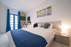 a bedroom with a large bed and a window at The Exiles Hotel in Sliema