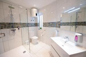 a bathroom with a shower and a toilet and a sink at The Exiles Hotel in Sliema