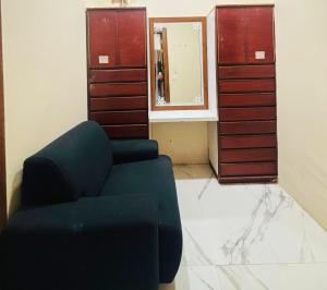a living room with a blue couch and a mirror at Amarvilas Hotel & Resort in Bharatpur