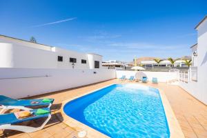 a swimming pool in the backyard of a house at Villa Gaida in Puerto Calero