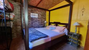 a bed in a room with a brick wall at Villa Hélèna Chalets in Sainte-Marie +43 photos