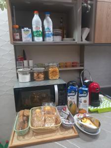 a kitchen counter with a microwave and some food at Stella Apartment in Lucera +5 photos
