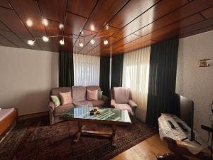 a living room with a couch and a table at Traumhafte Wohnung im Herzen von Zwiesel mit Garten in Zwiesel