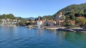 a view of a river with houses and a town at 4 Piano Apartment in Laveno-Mombello