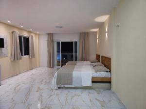 a large bedroom with a bed and a marble floor at Pousada Itarema Residence in Itarema +42 photos