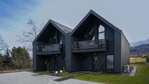 a black house with a black roof at Dom Czarna Owca - Widok na góry, sauna - SpaceApart in Karpacz
