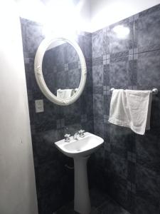 a bathroom with a sink and a mirror at Urku Wasi II in Chilecito
