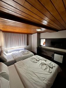 A bed or beds in a room at Gold Corner Hotel