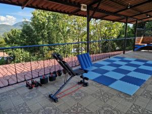 a chair on a patio with a view of mountains at Villa Wolfsbau in Pai