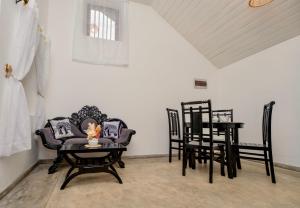 a dining room with chairs and a table and a table and a tableablish at La Coline 1957 Ahangama in Ahangama