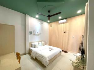 a bedroom with a bed and a ceiling fan at Ann Home in Ho Chi Minh City
