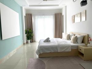 a bedroom with a large bed and a large window at Ann Home in Ho Chi Minh City +2 photos