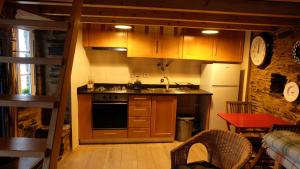 a kitchen with a sink and a stove top oven at Casa Cima in Chãs de Égua