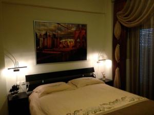 1 dormitorio con 1 cama grande y 2 lámparas en REM Apartments, en Tesalónica