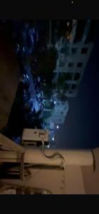 a television screen with a picture of a city at Panorama Elsherouk Furnished 2 bedroom apartment in Madīnat ash Shurūq